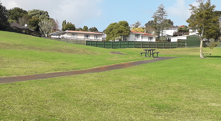 Te Kakau - Open space with a path and picnic table.