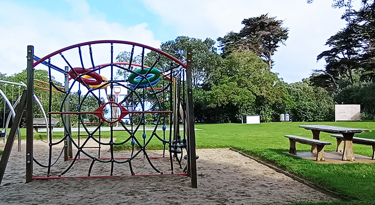 Surfdale Hall Reserve and Foreshore - Climbing nets with a picnic table and seating, and open grassed space on the right. Photo credit: K Sumner.