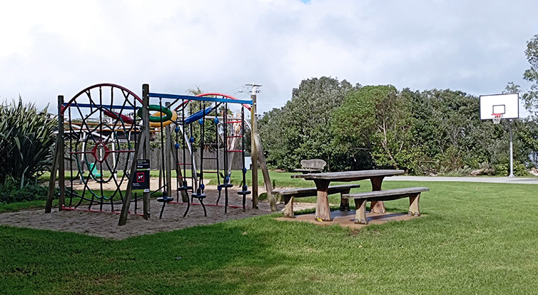 Surfdale Hall Reserve and Foreshore - Playground with climbing equipment and swings, with a nearby picnic table. Photo credit: K Sumner.