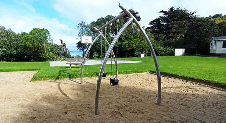 Surfdale Hall Reserve and Foreshore - Set of two swings with the basketball half-court in the background. Photo credit: K Sumner.