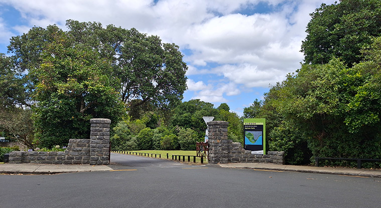 Sylvan Park - The entrance to the park and car park with a sign and trees in the background.