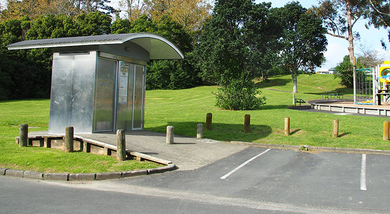 Taipari Strand – Toilet with a section of the car park in the foreground, and the playground and open space in the background. Photo credit: Tracey Hodder.