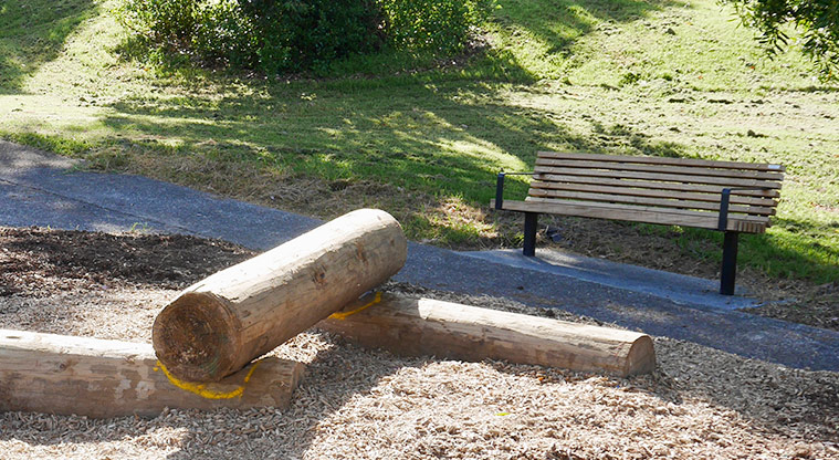 Taipari Strand - Large balance poles with a seat alongside the footpath.