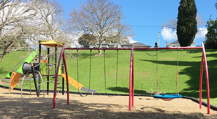 Taumata Reserve - Swing set with one of the play modules and the hill in the background. Photo credit: S Hulse.