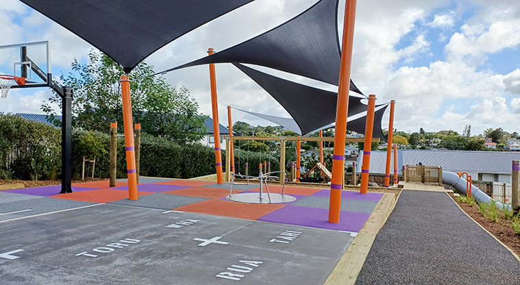Taurus Crescent Reserve - Playground with a basketball hoop, carousel, nature play, cubby house, tube slide and shade sails.