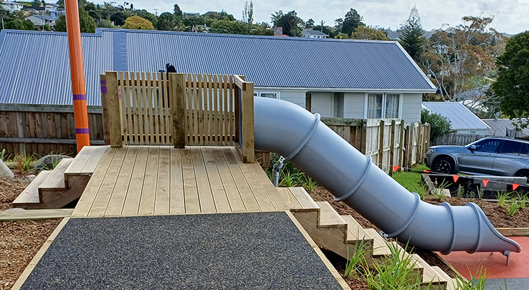 Taurus Crescent Reserve - Tube slide running down the slope from a wooden platform and steps up to the platform from both sides.