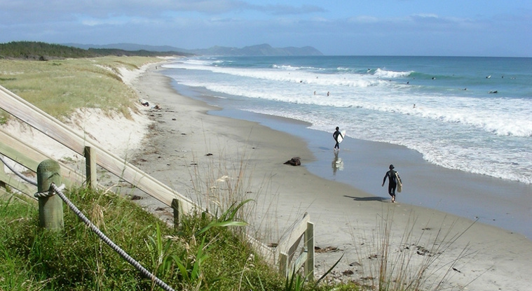 Te Ārai Regional Park - Surfers on Te Arai Beach.