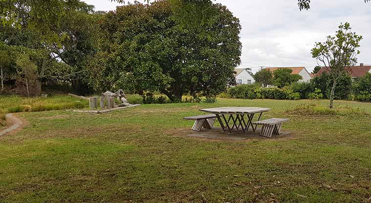 Underwood Park - one of the picnic tables with a section of the playground in the distance.