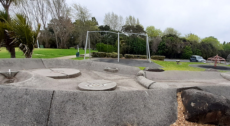 Wainoni Park North - Skate area with the swings, open space and a section of the car park in the background.