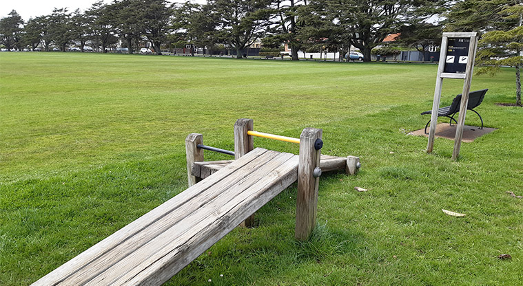 Walker Park - Fitness stations with sports fields in the background.