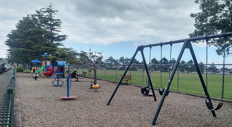 Walker Park - Playground with sports fields in the background.