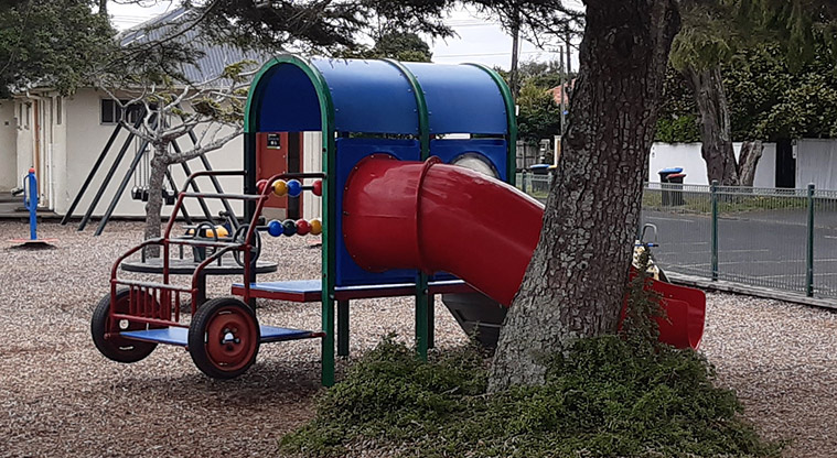 Walker Park - Play equipment in the shape of a truck with a tunnel slide.