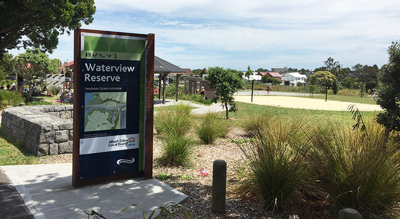 Waterview Reserve – Signage showing a map of the park, with the playground and volleyball court in the background.