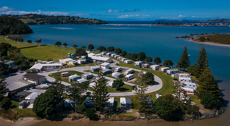 Whangateau Holiday Park - Aerial view of the park and harbour with Ti Point, Omaha and Horseshoe Lake in the background.