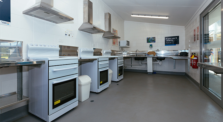 Whangateau Holiday Park - Guest kitchen with food preparation areas, ovens and washing up facilities.