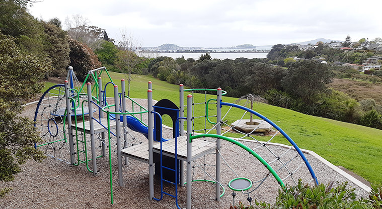 Wharua Reserve - Looking down onto the playground with open space, bush and views of the Hauraki Gulf Islands.