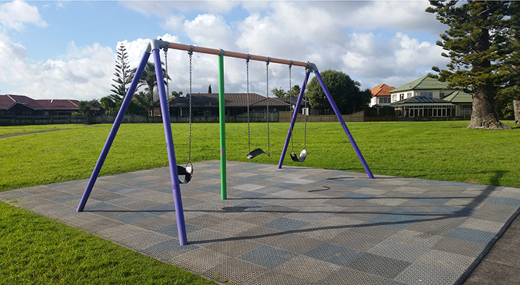 Golflands Loop Path - Playground swings at Frank Nobilo Reserve.
