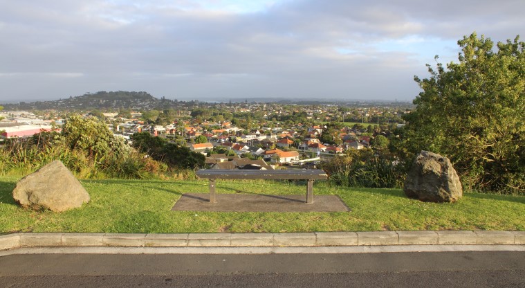 Pukewīwī / Puketāpapa / Mt Roskill Path - Bench nearing the tihi (summit) looking over Maungawhau / Mt Eden.