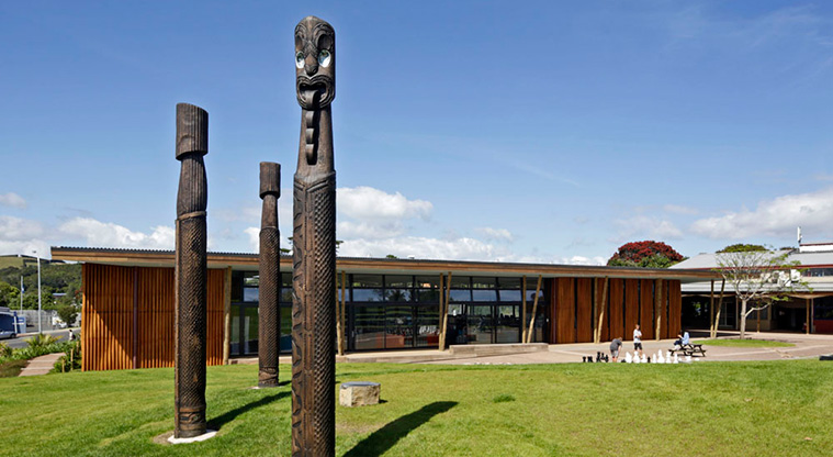 Oneroa Art Path - The three pou at Waiheke Library, Tikapa (front), Putiki o Kahu, and Piritaha 2014, Lucas Thompson, Chris Bailey, Pita Mahaki, Nico Otero, Hemi Thompson, Teddykoro Whatarangi, and others Auckland Council Art Collection.