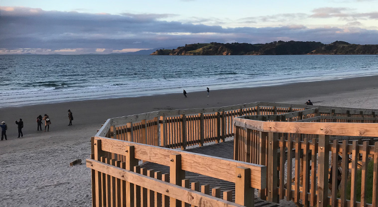 Onetangi Beach Path - The path starts at the middle of the beach. Take the ramp down to the beach or walk along the road.