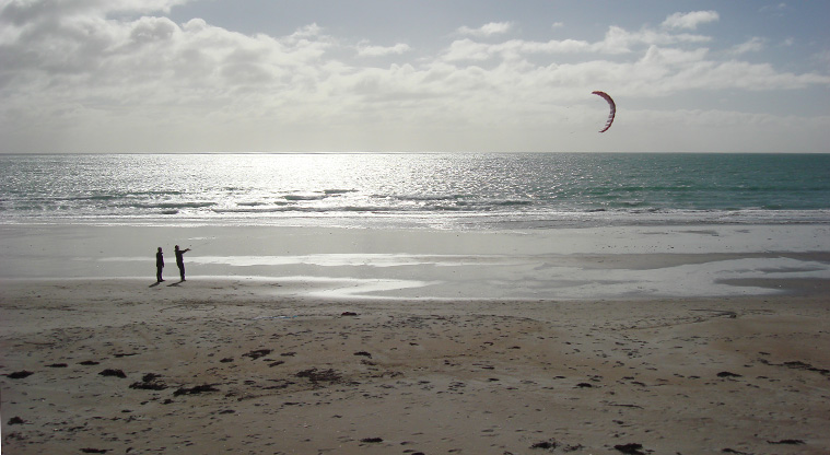 Onetangi Beach Path - On a windy day you may see kite surfers in action. If the surf is up, the eastern end of the beach is popular with surfers.