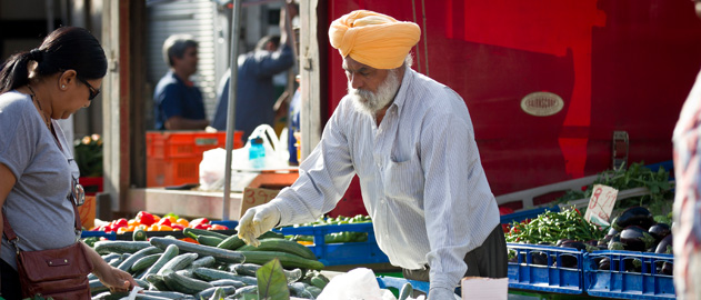A man selling vegetables in a market.