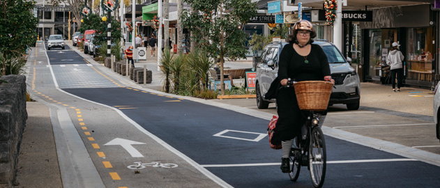 A woman cycling in Auckland city.