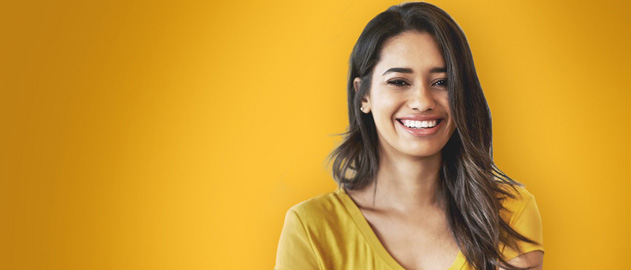 A young woman in a yellow t-shirt in front of a yellow background.