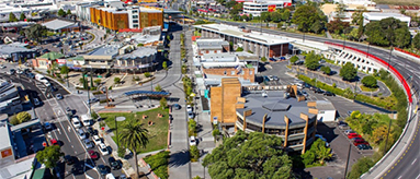 Aerial photo showing New Lynn's transport hub, retail areas and apartments.