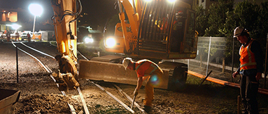 Photo of work being done on railway lines at night.