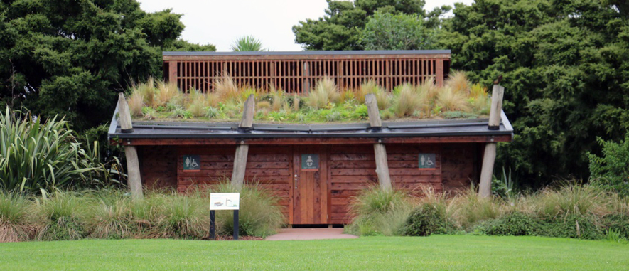 A toilet block at the Auckland Botanic Gardens, planted with grasses on its roof