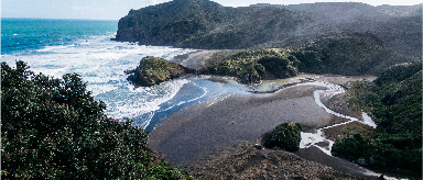 Photo of the beach and sea taken from high up on the hills.