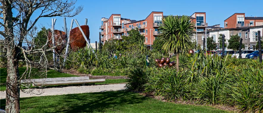 Photograph of playpark at Hobsonville point in the foreground with houses and apartments in the background