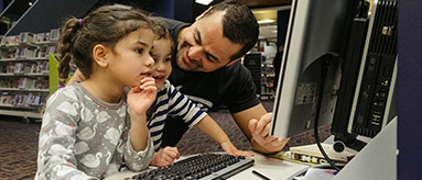 Photo of man and two children at the library.