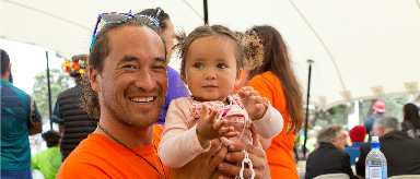 Photo of a man holding a small child.