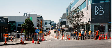 Photograph showing parts of a street blocked off and men at work