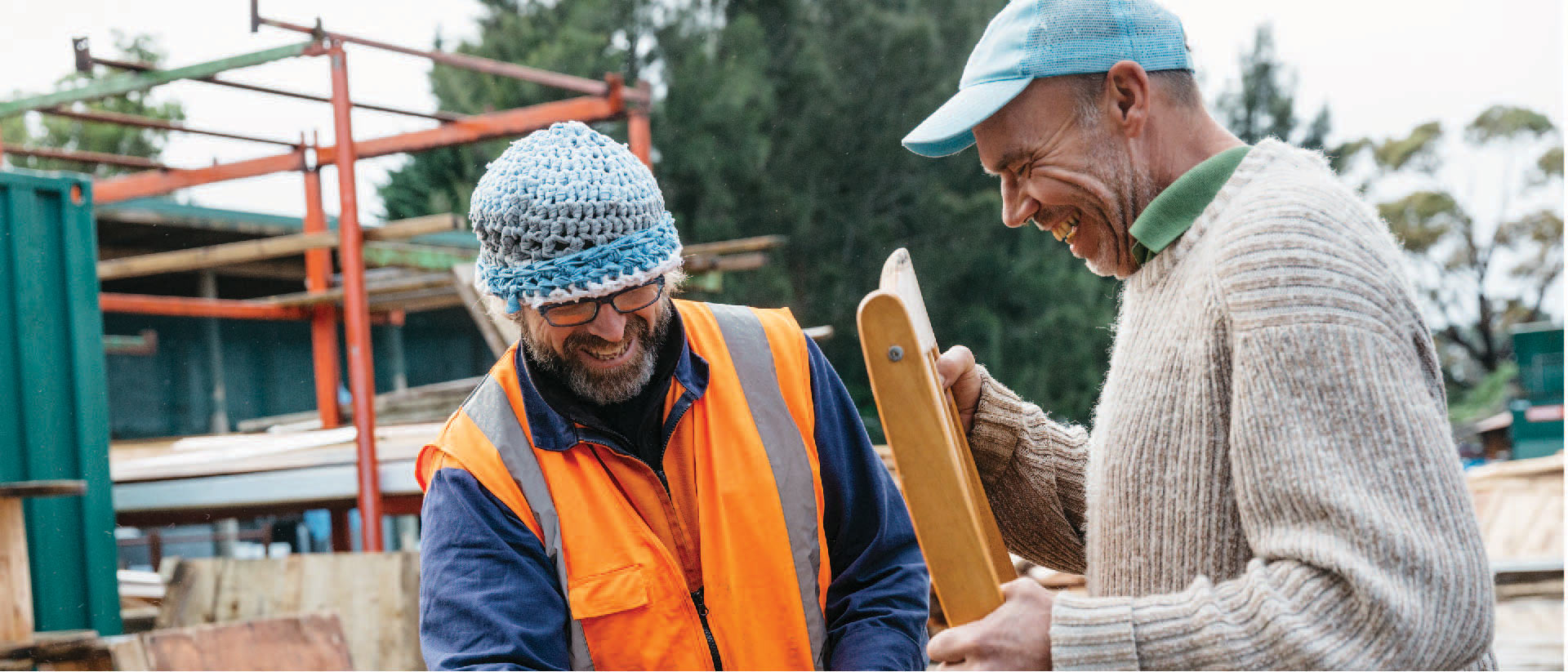 Two people repurposing a wooden chair at the Waitākere Refuse and Recycling Centre.