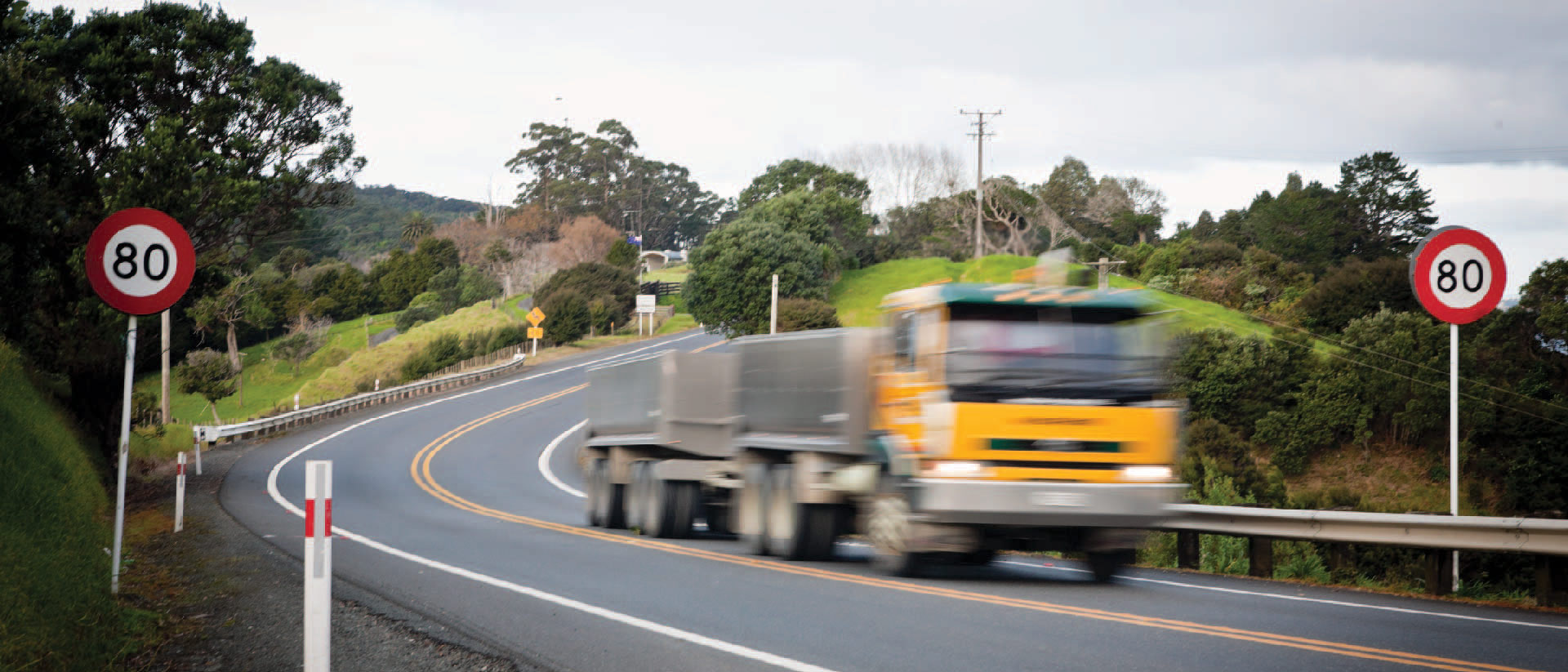 A freight truck driving along a highway.