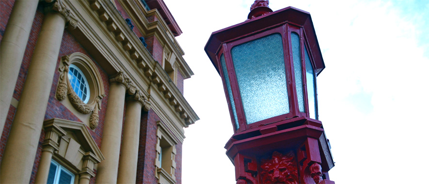 Old red street light in front of old building