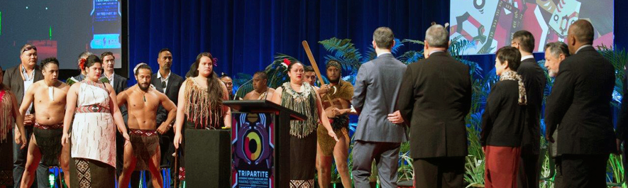 Photograph from Tripartite Economic Alliance showing a traditional Māori group welcoming international delegates.
